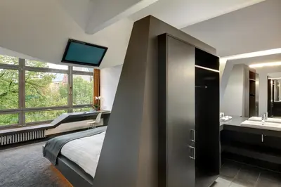 Ein Bett oder Betten in einem Zimmer der Unterkunft Aspria Berlin Ku'damm Sport & Spa
