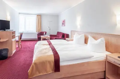 Ein Bett oder Betten in einem Zimmer der Unterkunft Sporthotel Neuruppin