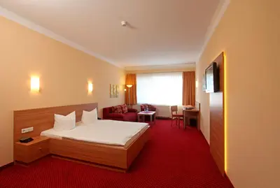 Ein Bett oder Betten in einem Zimmer der Unterkunft Sporthotel Neuruppin