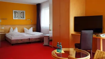 Ein Bett oder Betten in einem Zimmer der Unterkunft Hotel am Buschkrugpark