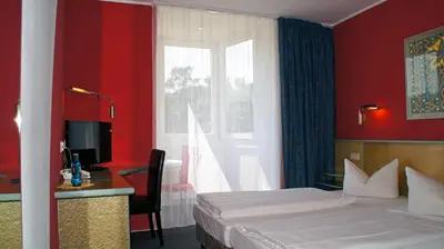 Ein Bett oder Betten in einem Zimmer der Unterkunft Hotel am Buschkrugpark