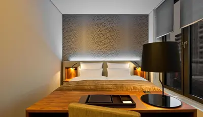 Ein Bett oder Betten in einem Zimmer der Unterkunft COSMO Hotel Berlin Mitte