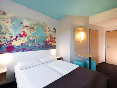 Ein Bett oder Betten in einem Zimmer der Unterkunft B&B Hotel Potsdam