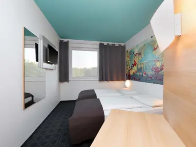 Ein Bett oder Betten in einem Zimmer der Unterkunft B&B Hotel Potsdam