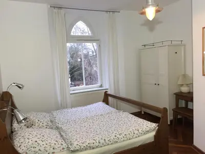 Ein Bett oder Betten in einem Zimmer der Unterkunft Lilienthalschlösschen