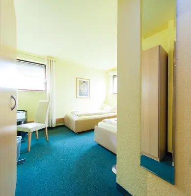 Ein Bett oder Betten in einem Zimmer der Unterkunft Garni-Hotel An der Weide