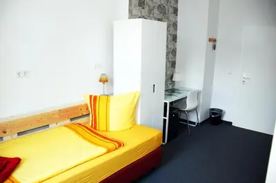 Ein Bett oder Betten in einem Zimmer der Unterkunft Botschaft
