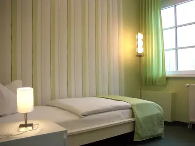 Ein Bett oder Betten in einem Zimmer der Unterkunft Altes Kasino Hotel am See
