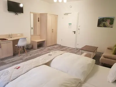 Ein Bett oder Betten in einem Zimmer der Unterkunft Neue Mühle Kleines Landhotel