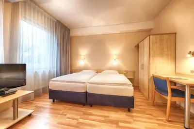 Ein Bett oder Betten in einem Zimmer der Unterkunft enjoy hotel Berlin City Messe