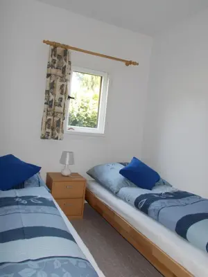 Ein Bett oder Betten in einem Zimmer der Unterkunft Ferienhaus am Langen See