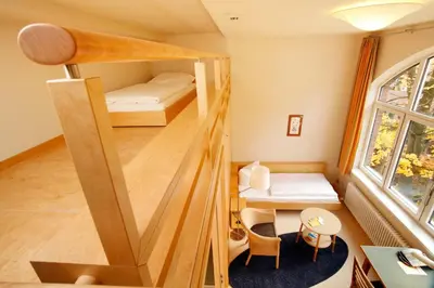 Ein Bett oder Betten in einem Zimmer der Unterkunft Gäste- und Tagungshaus am Glockengarten