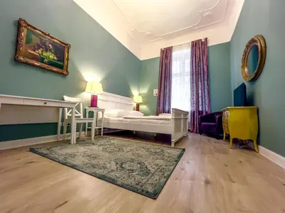 Ein Bett oder Betten in einem Zimmer der Unterkunft Apartments-Maison Am Olivaer Platz