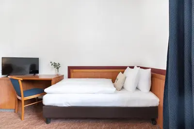 Ein Bett oder Betten in einem Zimmer der Unterkunft Hotel Aldea Berlin