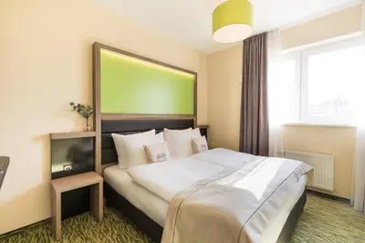 Ein Bett oder Betten in einem Zimmer der Unterkunft Hotel Aldea Berlin