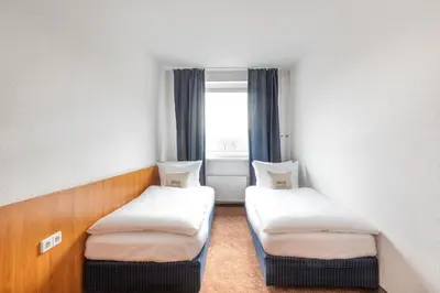 Ein Bett oder Betten in einem Zimmer der Unterkunft Hotel Aldea Berlin