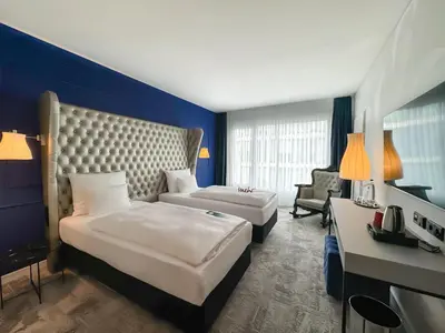Ein Bett oder Betten in einem Zimmer der Unterkunft ARCOTEL John F Berlin