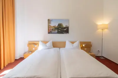 Ein Bett oder Betten in einem Zimmer der Unterkunft Hotel 26