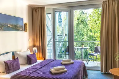 Ein Bett oder Betten in einem Zimmer der Unterkunft Hotel Ambiente Berlin City
