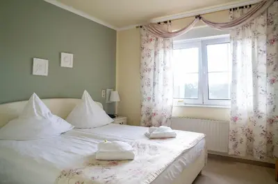 Ein Bett oder Betten in einem Zimmer der Unterkunft Hotel Am Wald B&B