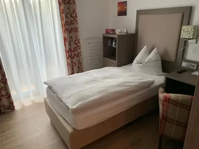 Ein Bett oder Betten in einem Zimmer der Unterkunft Gästehaus Alpinia