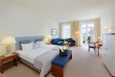 Ein Bett oder Betten in einem Zimmer der Unterkunft Sunday Resort Schwielowsee - Hotel