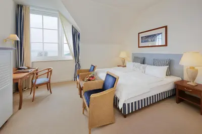 Ein Bett oder Betten in einem Zimmer der Unterkunft Sunday Resort Schwielowsee - Hotel