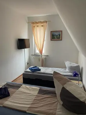 Ein Bett oder Betten in einem Zimmer der Unterkunft LEKOMA Pension