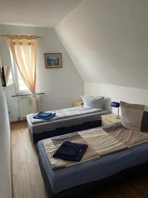 Ein Bett oder Betten in einem Zimmer der Unterkunft LEKOMA Pension