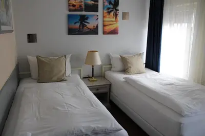 Ein Bett oder Betten in einem Zimmer der Unterkunft Pension Oase
