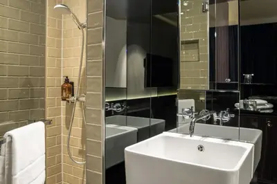 Ein Badezimmer in der Unterkunft Hotel MANI by AMANO