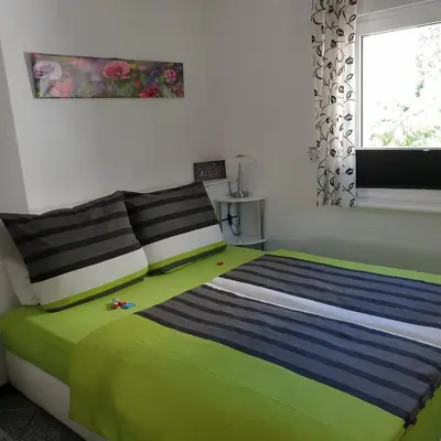Ein Bett oder Betten in einem Zimmer der Unterkunft Ferienapartment MOHNBLUME