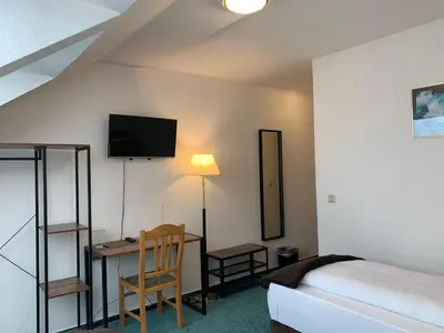 Ein Bett oder Betten in einem Zimmer der Unterkunft Hotel Rosengarten
