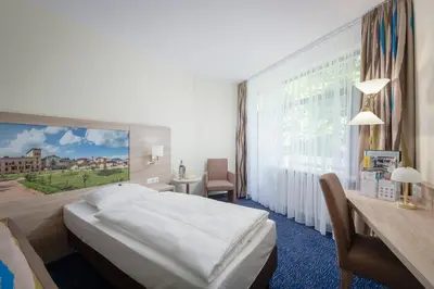 Ein Bett oder Betten in einem Zimmer der Unterkunft Seehotel Grunewald