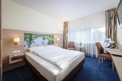 Ein Bett oder Betten in einem Zimmer der Unterkunft Seehotel Grunewald