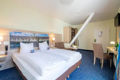 Ein Bett oder Betten in einem Zimmer der Unterkunft Seehotel Grunewald