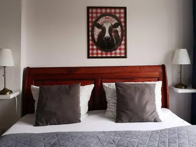 Ein Bett oder Betten in einem Zimmer der Unterkunft Landlust Hotel