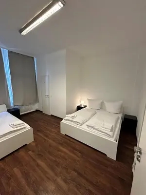 Ein Bett oder Betten in einem Zimmer der Unterkunft Potsdamer Inn