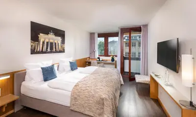 Ein Bett oder Betten in einem Zimmer der Unterkunft Hotel Aquino Berlin