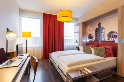 Ein Bett oder Betten in einem Zimmer der Unterkunft Aparthotel Adagio Berlin Kurfürstendamm