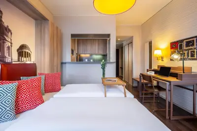 Ein Bett oder Betten in einem Zimmer der Unterkunft Aparthotel Adagio Berlin Kurfürstendamm