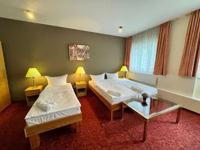 Ein Bett oder Betten in einem Zimmer der Unterkunft Hotel Bonverde (Wannsee-Hof)