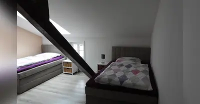 Ein Bett oder Betten in einem Zimmer der Unterkunft Ferienwohnung Olafs Werkstatt