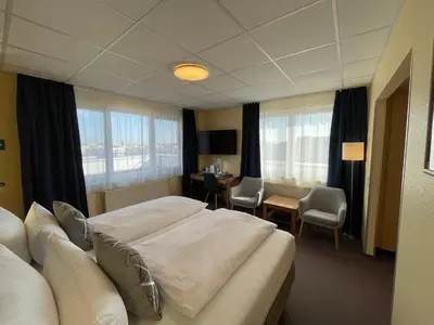 Ein Bett oder Betten in einem Zimmer der Unterkunft Parkhotel Marzahn
