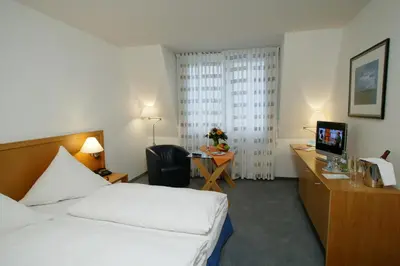 Ein Bett oder Betten in einem Zimmer der Unterkunft Stadthotel Oranienburg