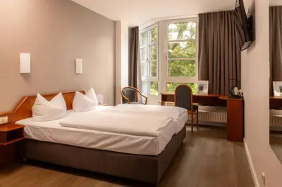 Ein Bett oder Betten in einem Zimmer der Unterkunft SensCity Hotel Berlin Spandau