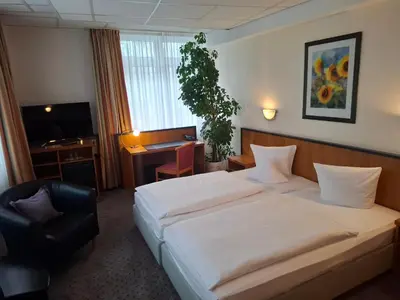 Ein Bett oder Betten in einem Zimmer der Unterkunft Andersen Hotel Birkenwerder
