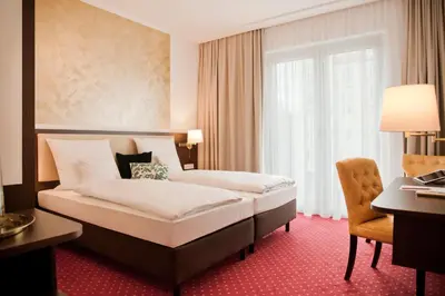 Ein Bett oder Betten in einem Zimmer der Unterkunft Gold Palais Hotel