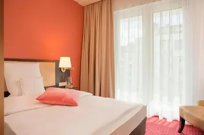 Ein Bett oder Betten in einem Zimmer der Unterkunft Gold Palais Hotel