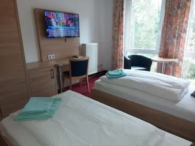 Ein Bett oder Betten in einem Zimmer der Unterkunft Hotel Sperlingshof